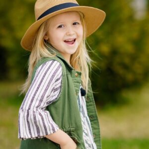 selective focus photography of girl smiling wearing sun hat