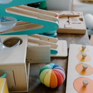 Montessori-style colorful wooden toys on a table promoting educational play for children.