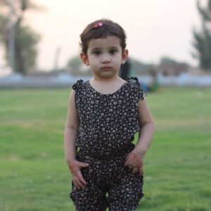 a girl standing in a grassy area