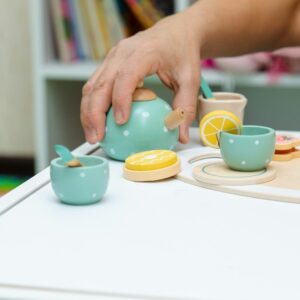 a person is putting a lemon in a teapot