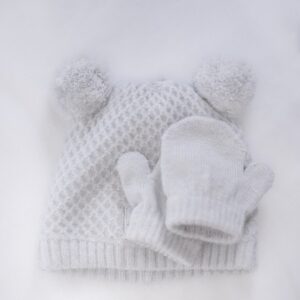 a white knitted hat and mitten on a white background