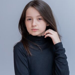 A young girl is posing for a picture