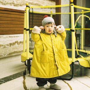 girl wearing yellow jacket and gray bennies
