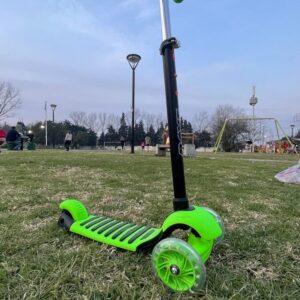 a green lawn mower on a grass field