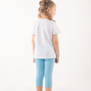 a little girl wearing blue leggings and a white t - shirt