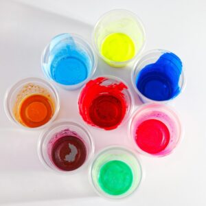 red blue green and yellow round plastic containers