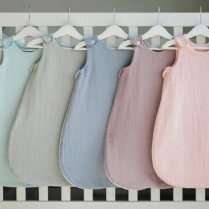 a row of baby swaddles hanging from a crib